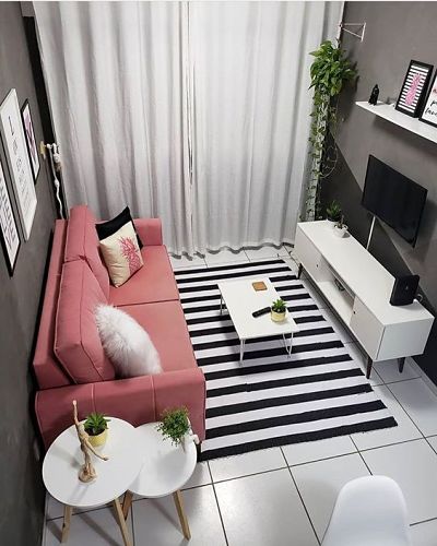 Sala com sofá rosa e paredes escuras